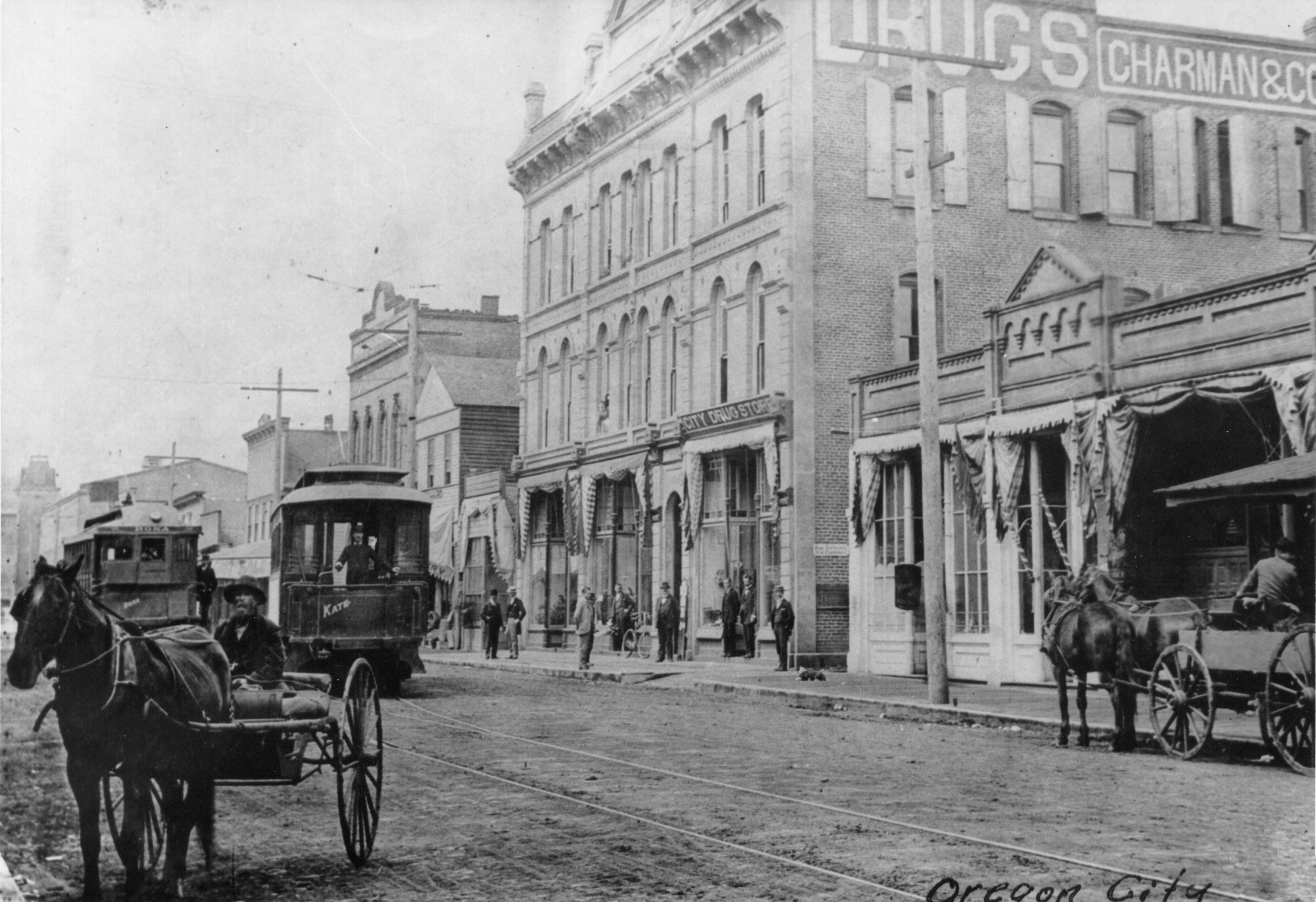 East Side Railway cars Bona and Kate passing on Main St. in Oregon City, 1890s.