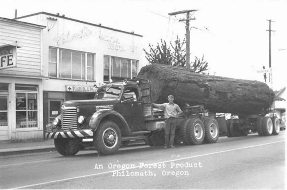 Don Maddux poses with a log truck in Philomath, about 1950. 