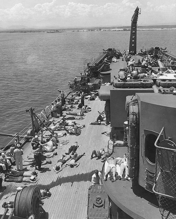 Crew sunbathing on the after deck of the U.S.S. Oregon City (CA-122), 1946.