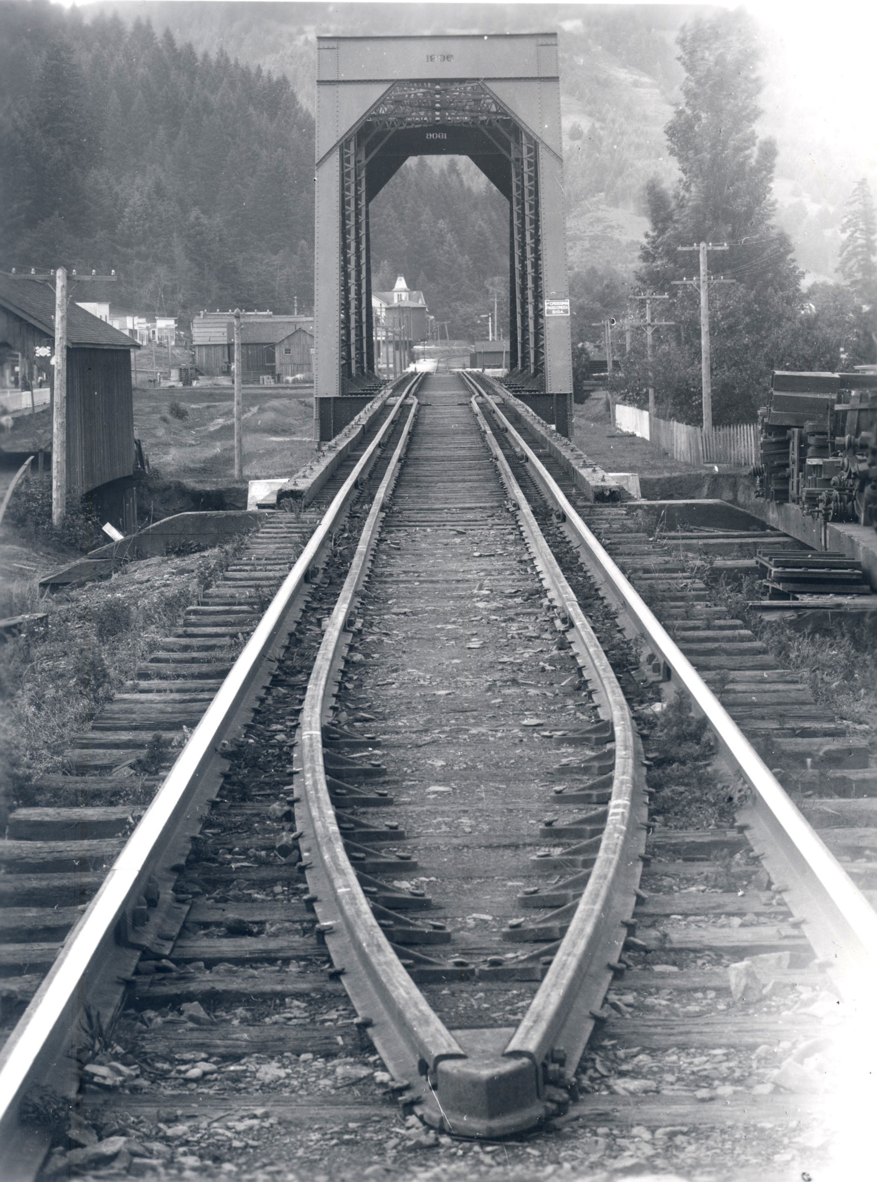 The covered bridge can be seen to the left of the first railroad crossing on Pass Creek. 