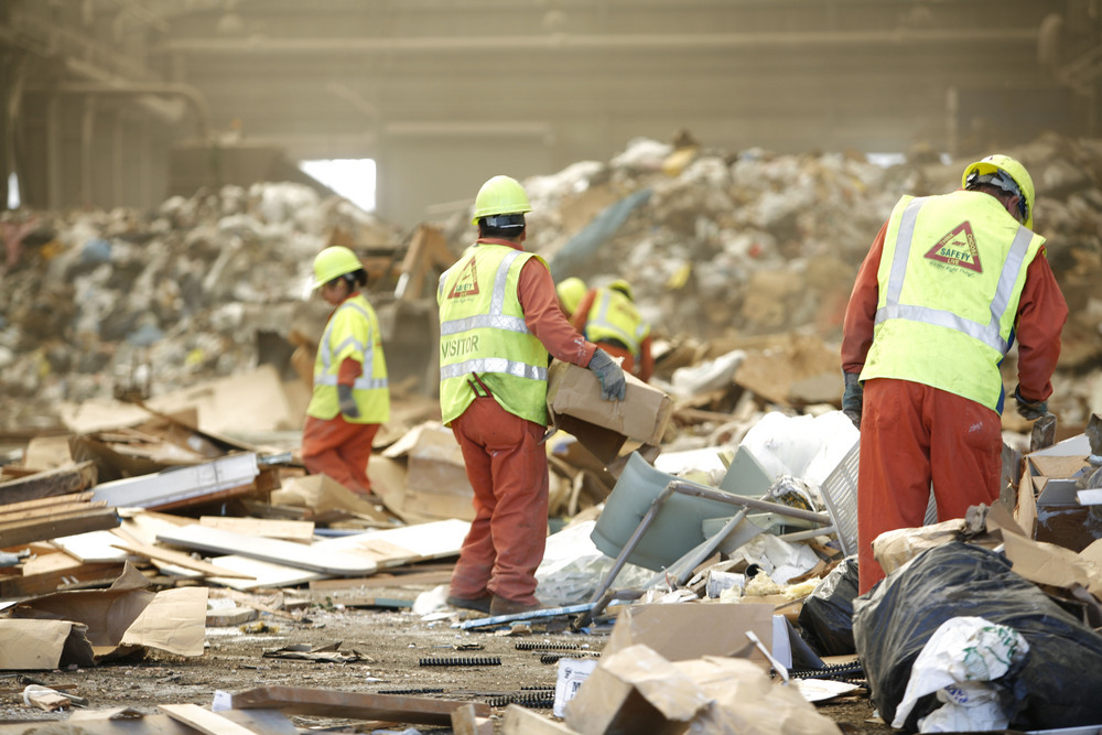 Workers sorting materials for recovery at Metro's solid waste transfer station, Portland.