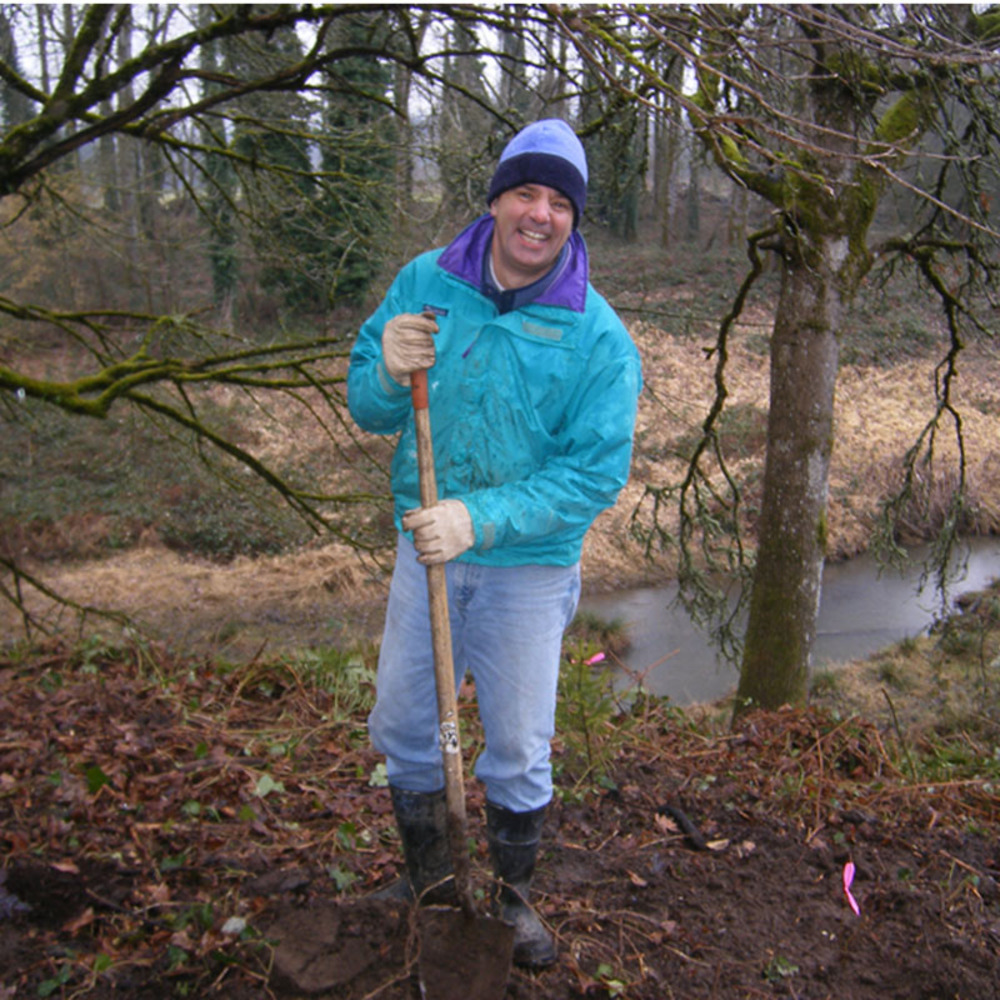 SOLV volunteer plants trees at a restoration site, February 2009.