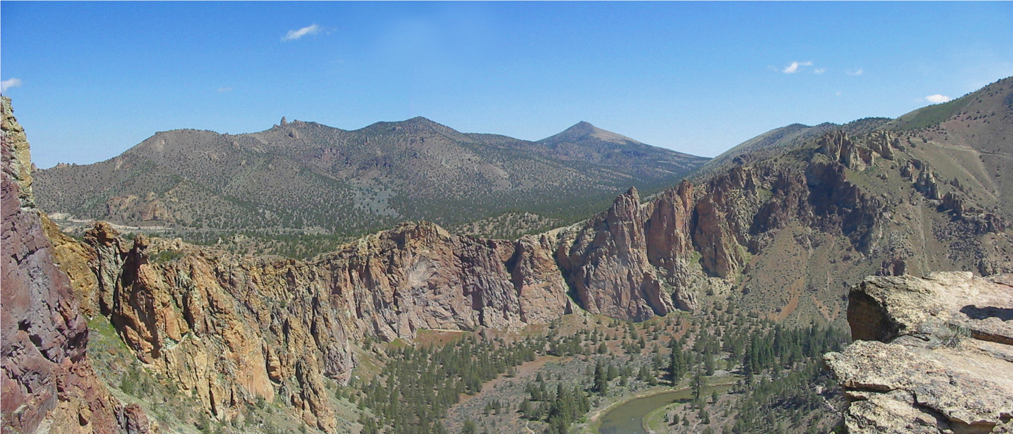 Spire forming exposures of tuff, north frm Misery Ridge. Gray Butte (in distance) is rhyolite dome, north edge of Crooked R. caldera.