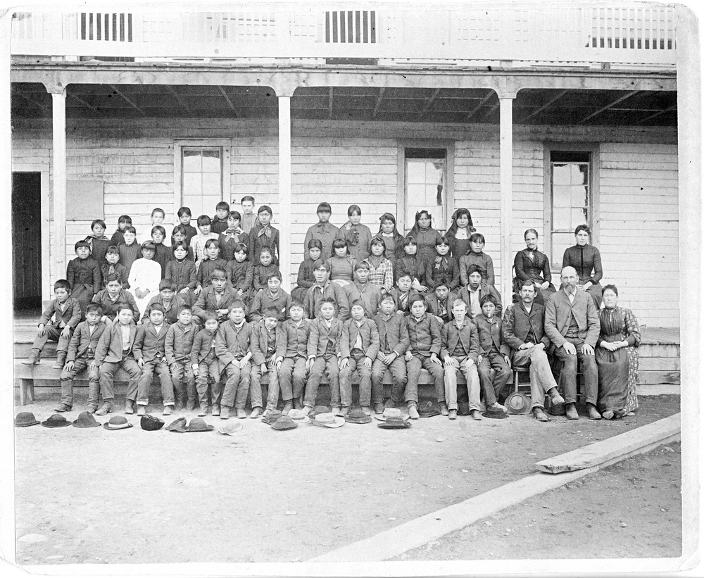Students and staff stand in front of the Warm Springs Indian Training School in 1890.