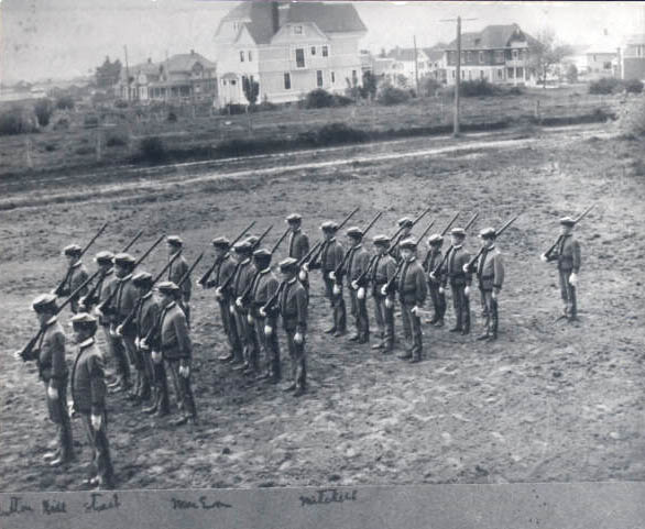 Cadets drill in a lot near the school.